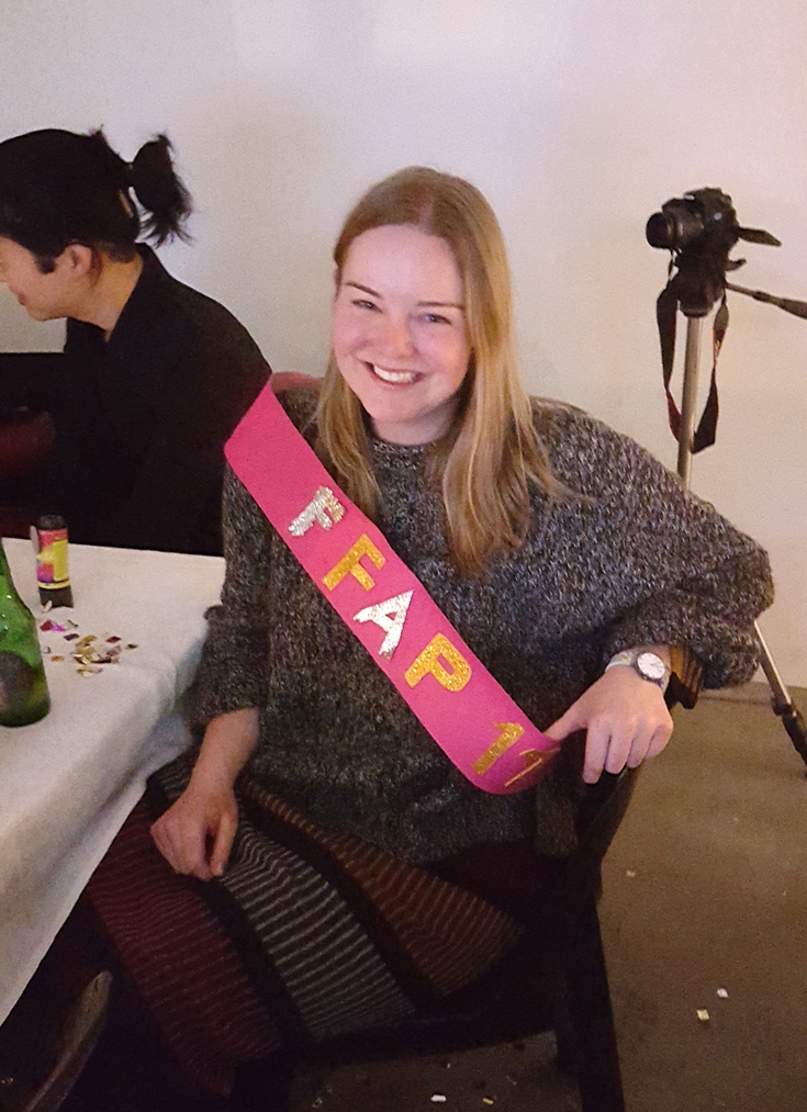 Hope Wilson, Assistant Curator at the Physics Room, is pictured smiling as she wears the official FFAP 2017 sash.